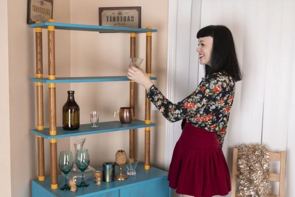 Little Olive models by her blue sideboard
