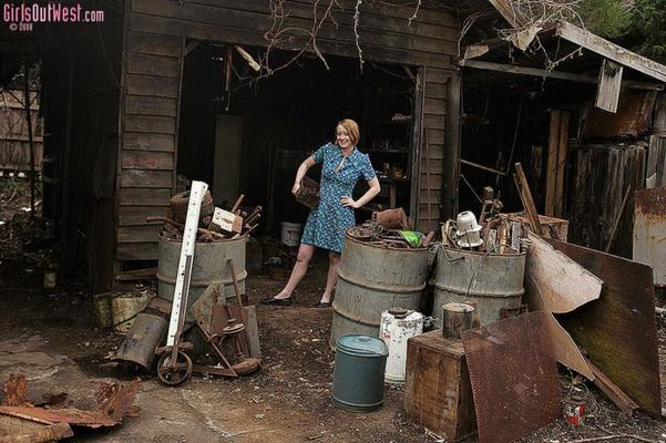 Redhead Eve cleaning the barn