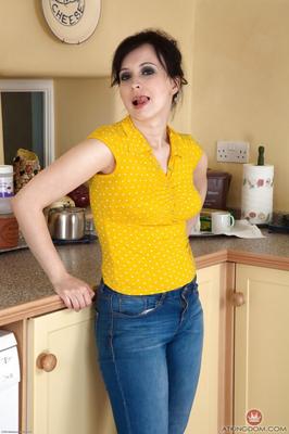 Chubby mature lady Nikita showing off hairy pussy on kitchen cou
